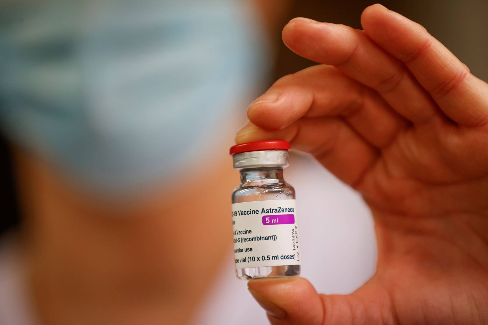A member of the medical staff holds a vial of the AstraZeneca-Oxford COVID-19 vaccine, in Melun