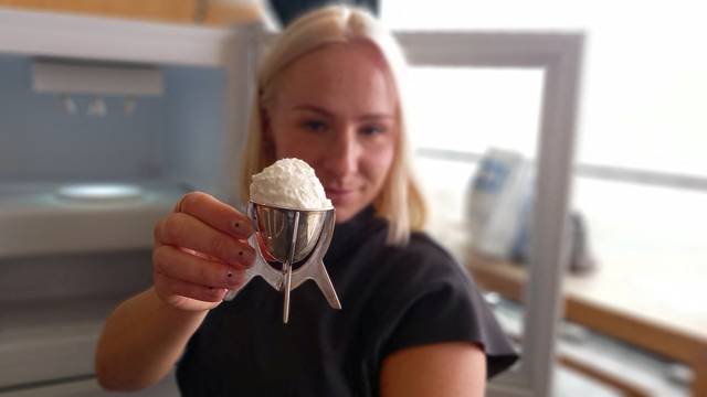 A view shows the world's first vanilla ice cream made with plastic waste, held up for the camera by its maker, artist and designer Eleanora Ortolani at Central Saint Martins in London