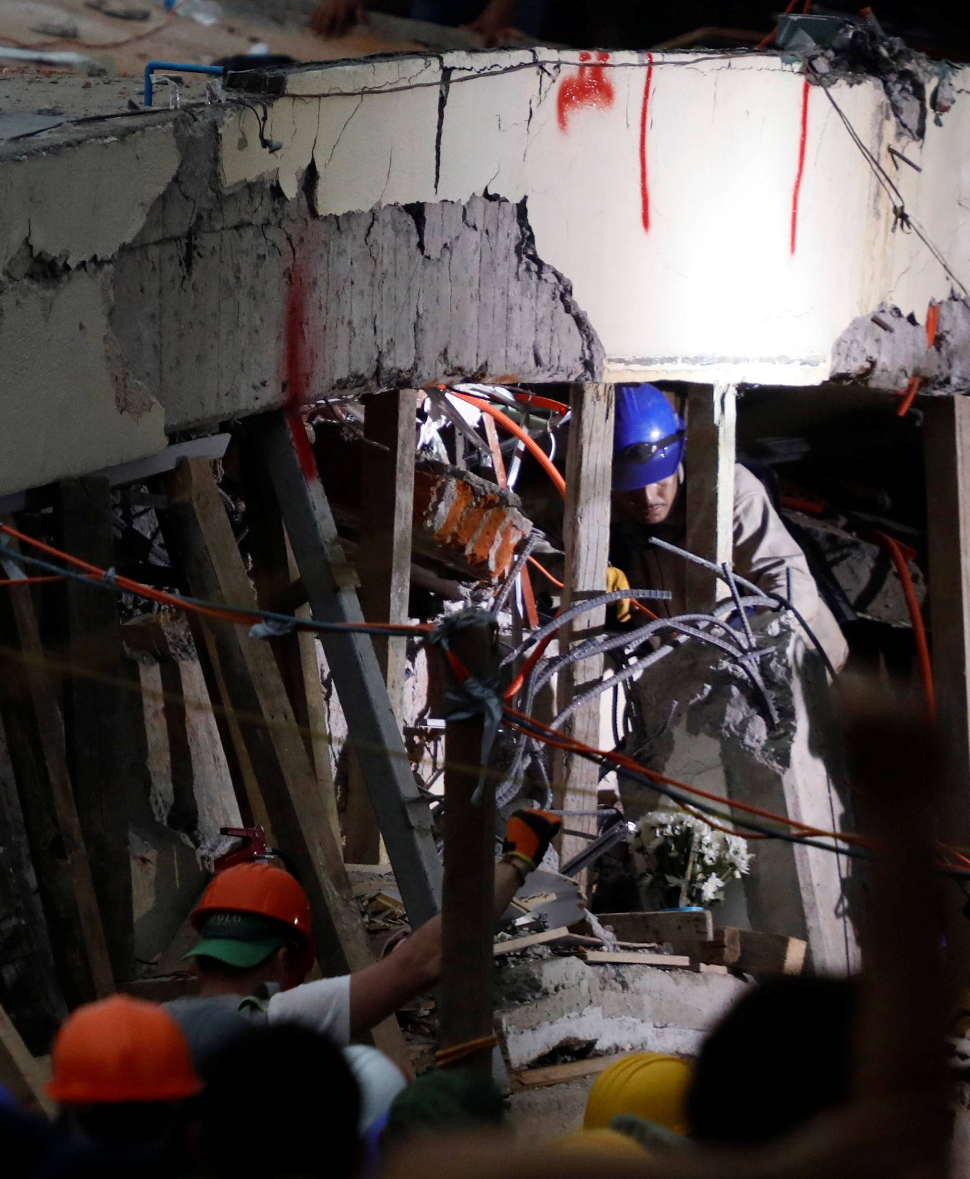 Rescue workers search through the rubble for students at Enrique Rebsamen school after an earthquake in Mexico City