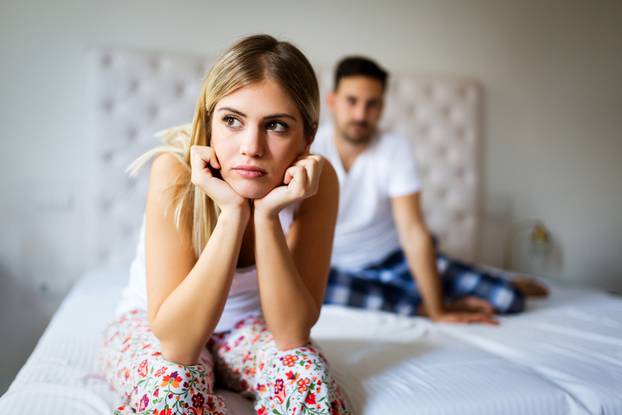 Young unhappy couple having problems in relationship