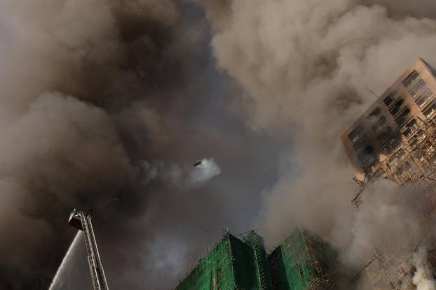 Flames engulf bamboo scaffolding across multiple buildings at Wang Fuk Court housing estate, in Tai Po
