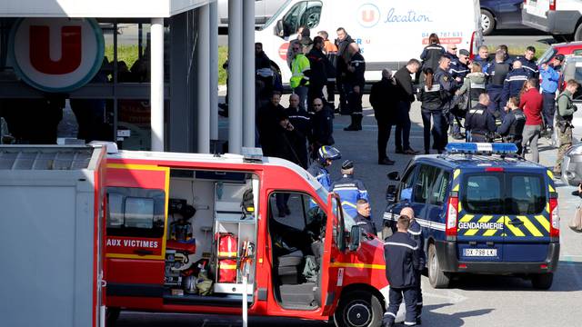 A general view shows gendarmes and police officers at a supermarket after a hostage situation in Trebes