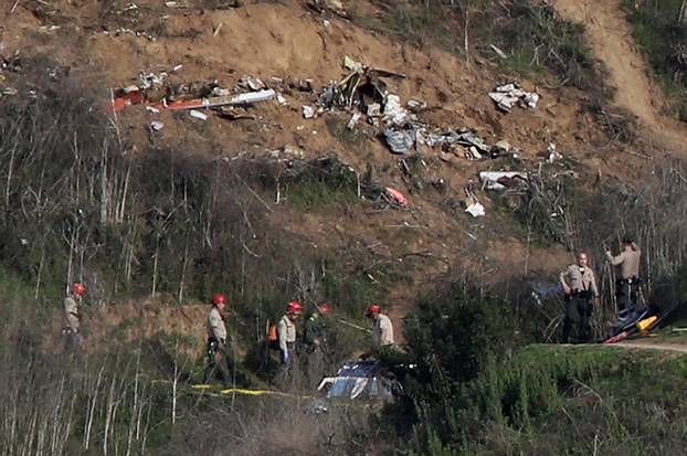 Sheriffs and officials investigate the helicopter crash site of NBA star Kobe Bryant in Calabasas, California