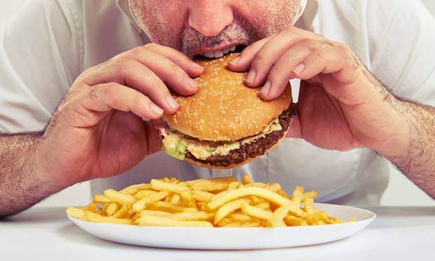 Close,Up,Photo,Of,Man,Eating,Burger,And,French,Fries