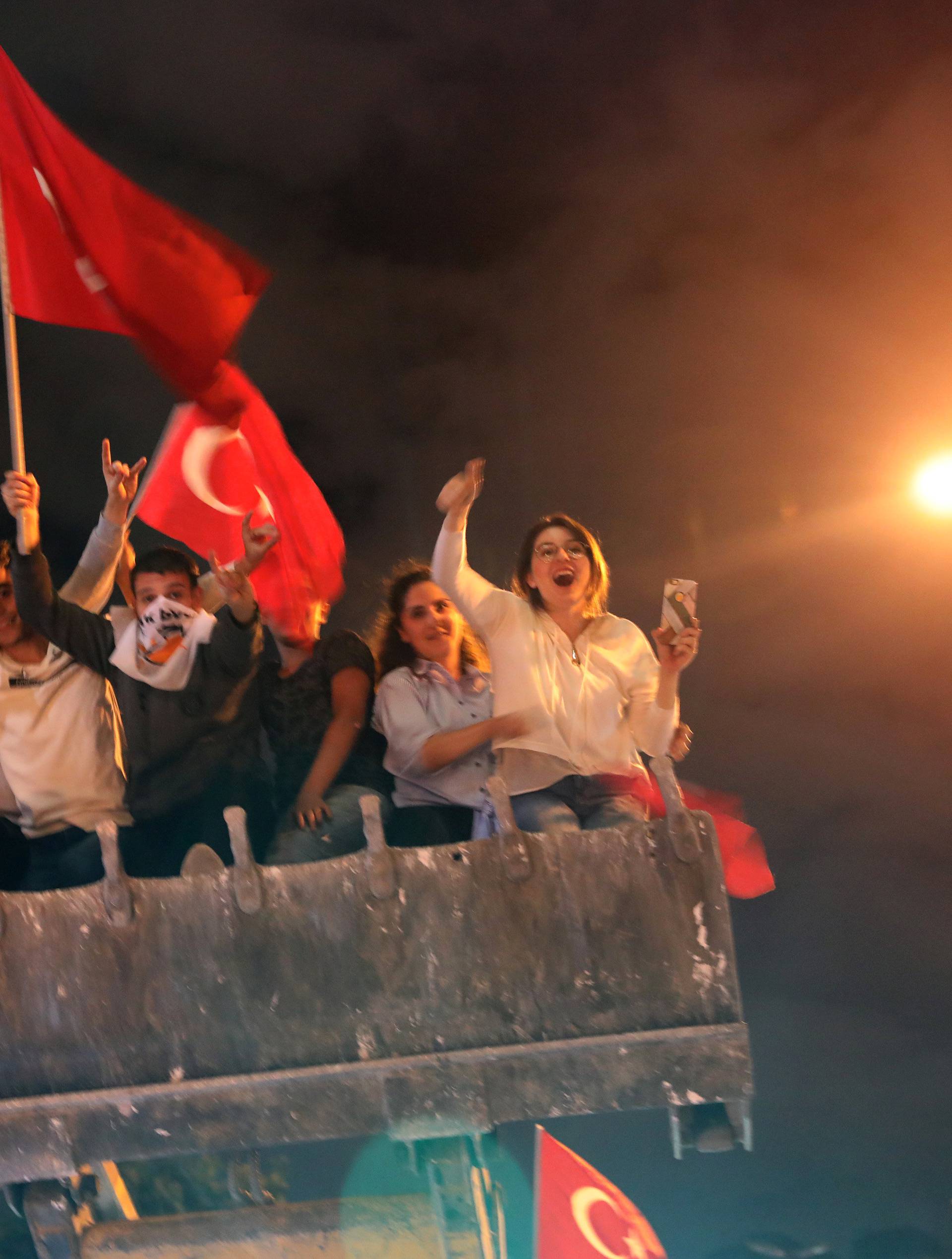 Supporters of Turkish President Tayyip Erdogan cheer in front of Turkey's ruling AK Party (AKP) headquarters in Istanbul
