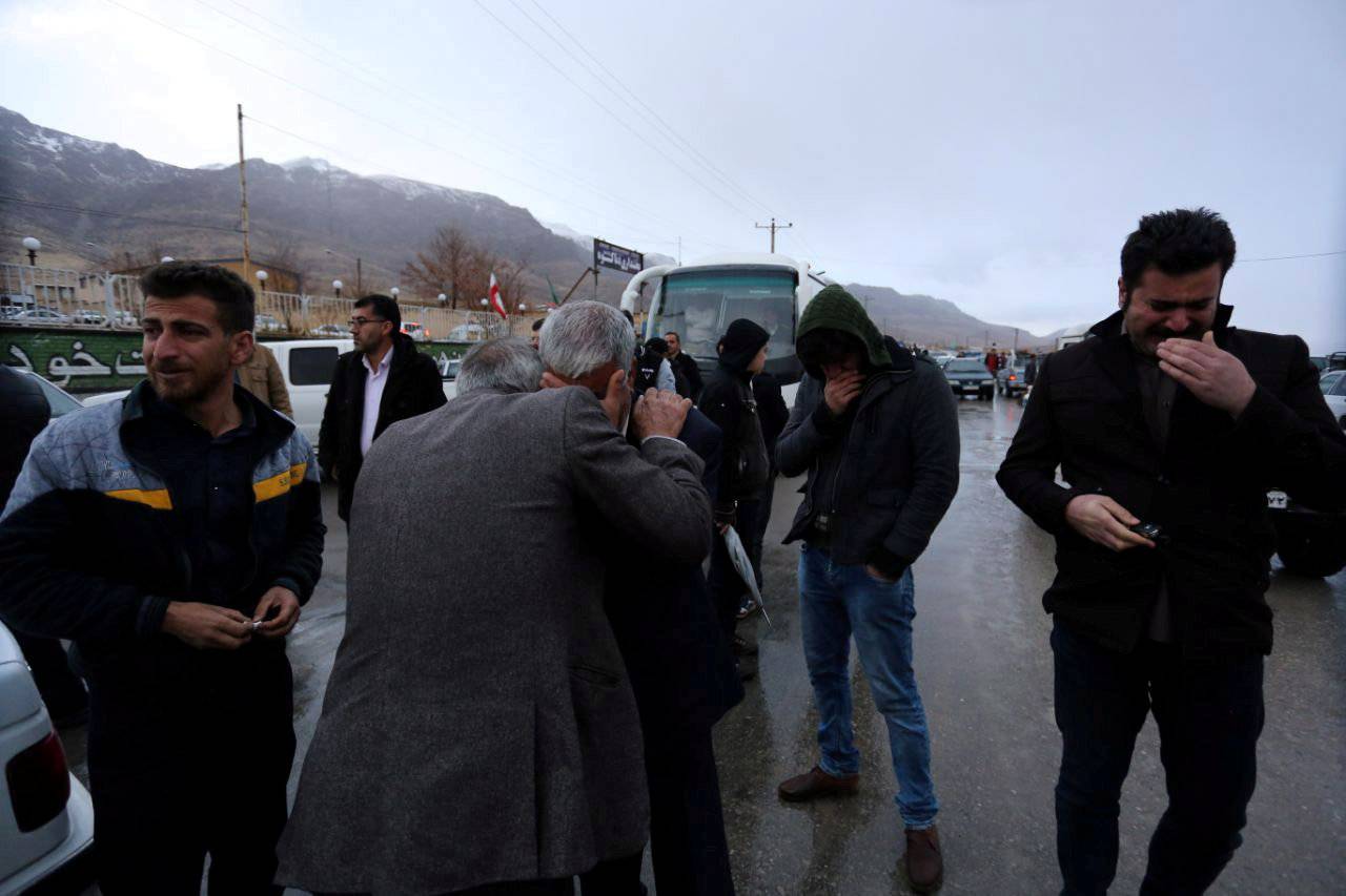 Relatives of passengers who were believed to have been killed in a plane crash react near the town of Semirom