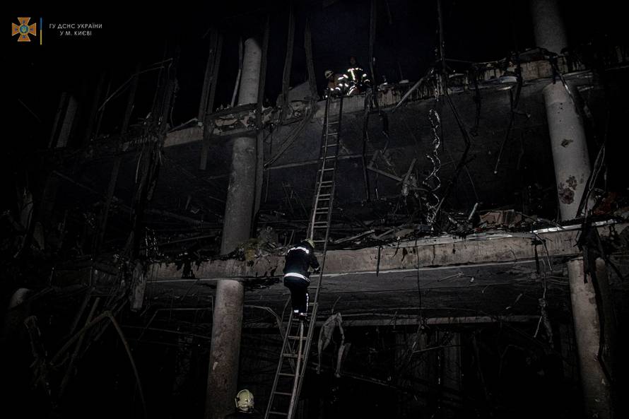 Rescuers work at the site of a shopping mall damaged by an airstrike in Kyiv