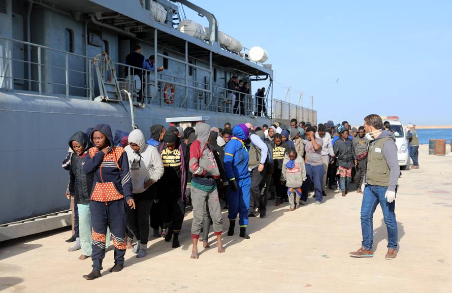 Migrants arrive at a naval base after they were rescued by Libyan coast guards, at a naval base in Tripoli