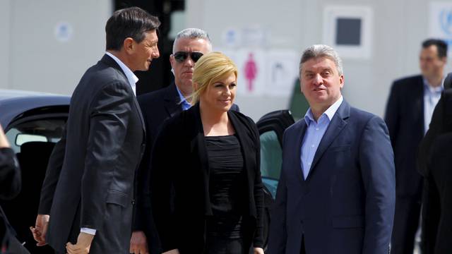 Slovenia's President Borut Pahor, Croatia's President Kolinda Grabar Kitarovic and their Macedonian counterpart Gjorge Ivanov arrive at Vinojug migrants camp in Gevgelija