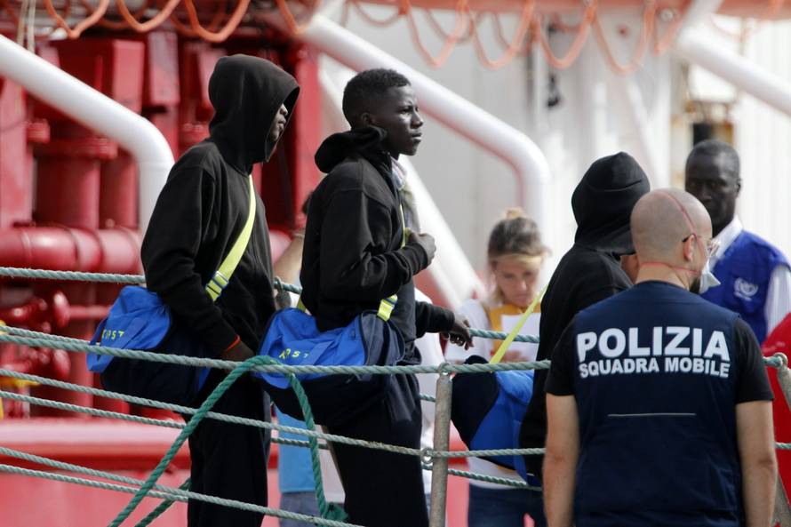 Migrants disembark at the port of Pozzallo after spending nearly two weeks on board the Medecins Sans Frontieres (MSF)-operated Ocean Viking