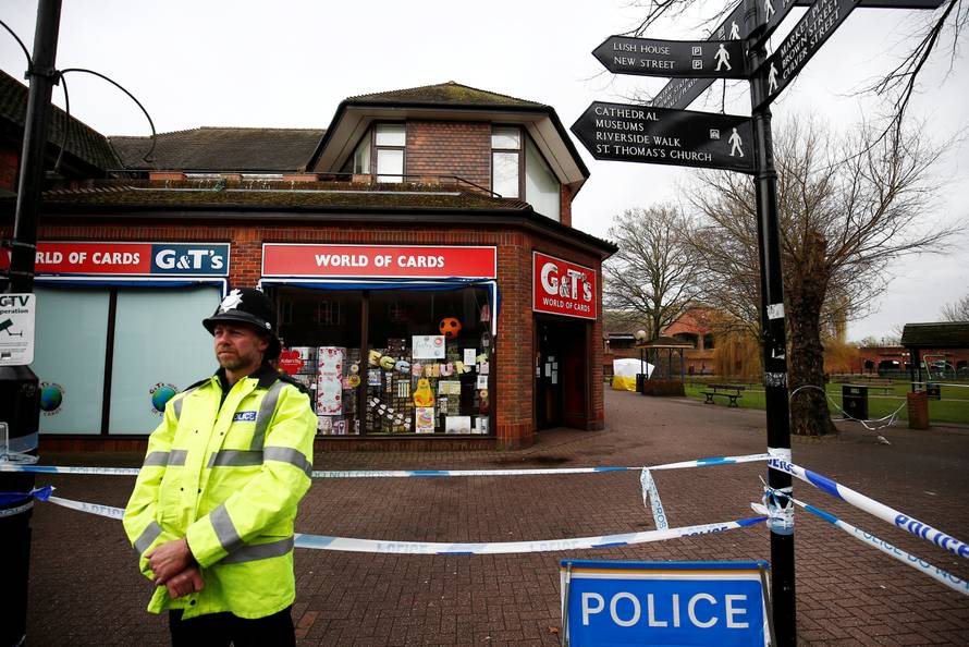 A police officer stands at a cordon around the bench where former Russian inteligence agent Sergei Skripal and his daughter Yulia were found after they were poisoned, in Salisbury