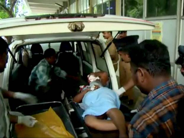 An injured person is attended to at a hospital, after a fire broke out as people gathered for a fireworks display at a temple in Kollam