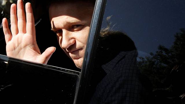 FILE PHOTO: Prominent anti-corruption blogger Alexei Navalny greets supporters inside a car after being released from a police station in Moscow