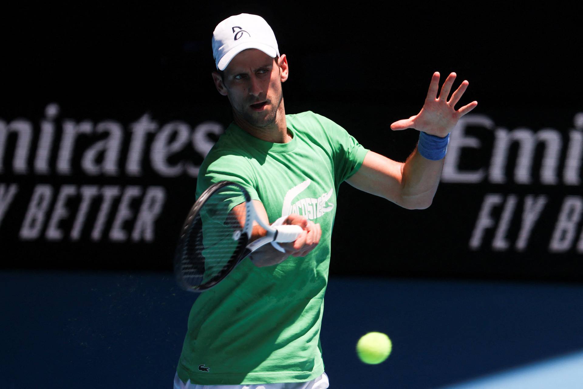 Serbian tennis player Novak Djokovic practices at Melbourne Park as questions remain over the legal battle regarding his visa to play in the Australian Open