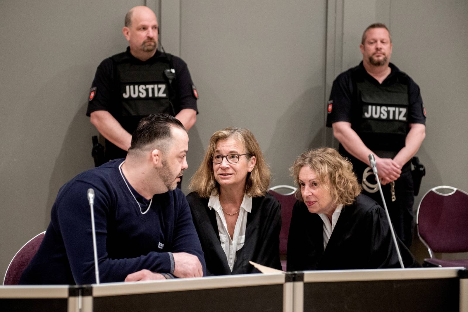 FILE PHOTO: Niels Hoegel, accused of murdering 100 patients at the clinics in Delmenhorst and Oldenburg, speaks to his lawyer Ulrike Baumann during his trial in Oldenburg