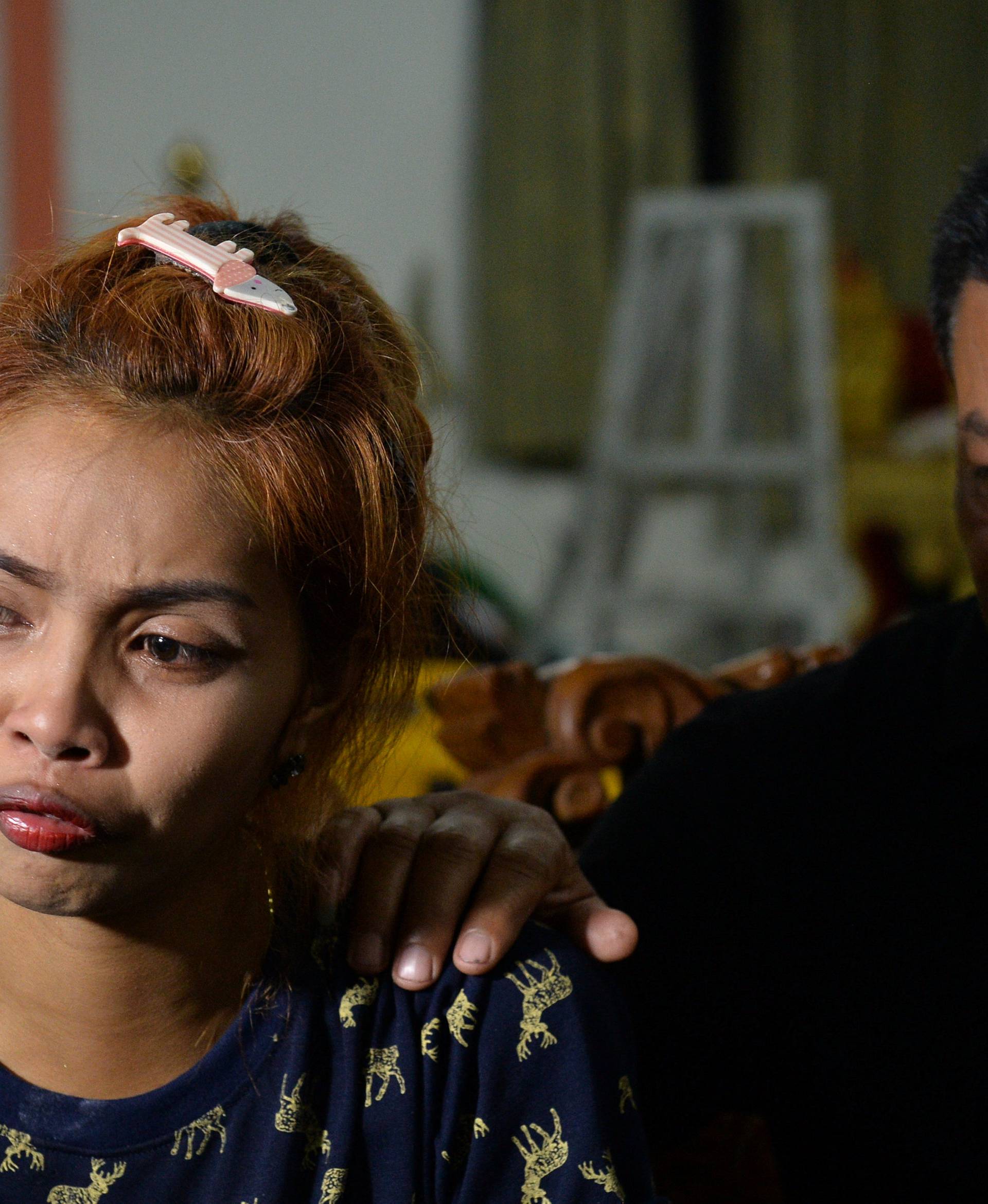 Jiranuch Trirat is comforted her by father at a temple in Phuket