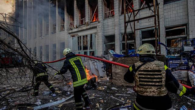 Rescuers work at a site of an industrial building damaged by an airstrike in Kyiv