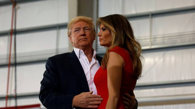 U.S. President Donald Trump hugs his wife Melania during a "Make America Great Again" rally at Orlando Melbourne International Airport in Melbourne, Florida, U.S.