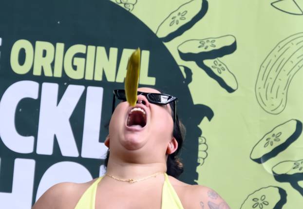 Visitors to Picklesburgh Try Catching Pickles in their Mouth