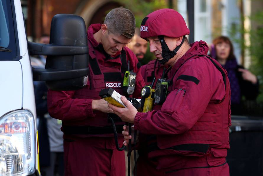 Members of a bomb disposal squad stand in the street near Parsons Green tube station in London