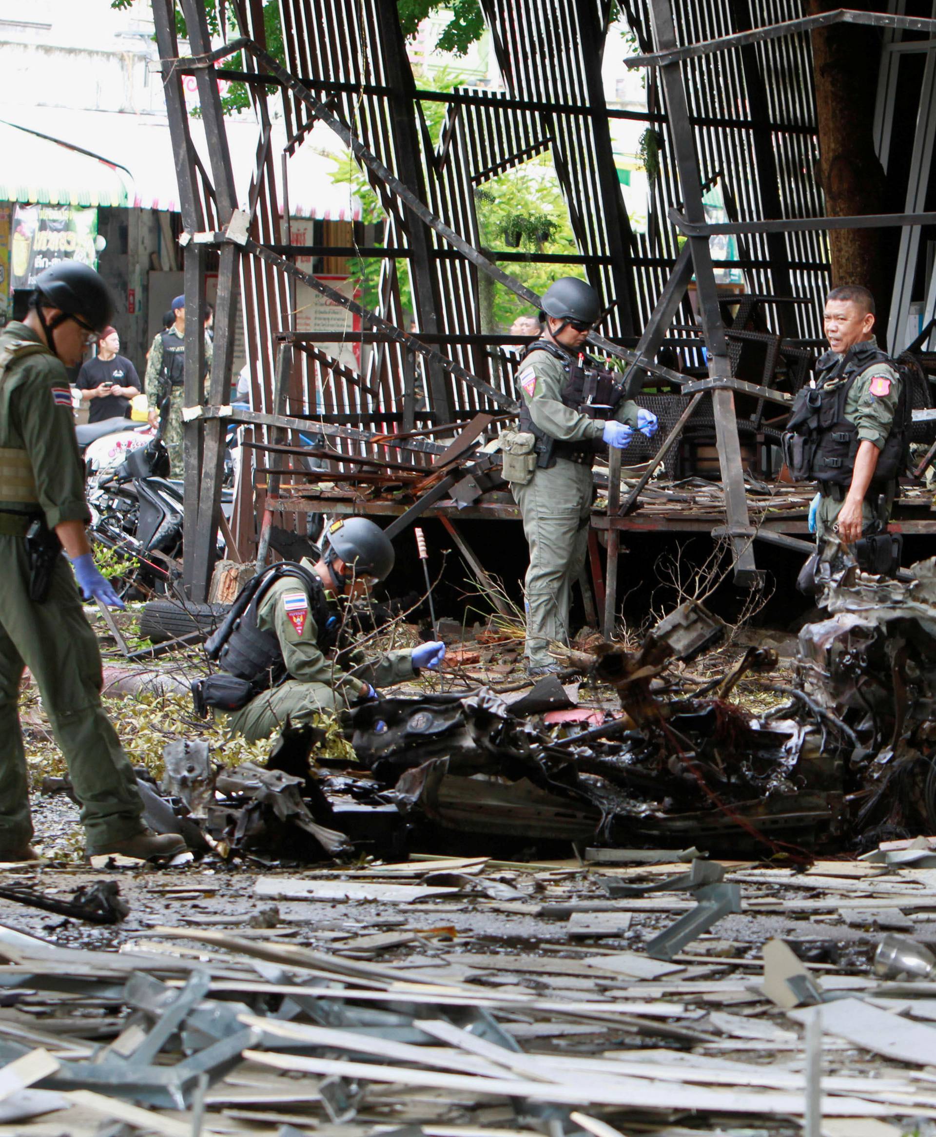 Thai soldiers inspect the scene of a car bomb blast outside a hotel in the southern province of Pattani