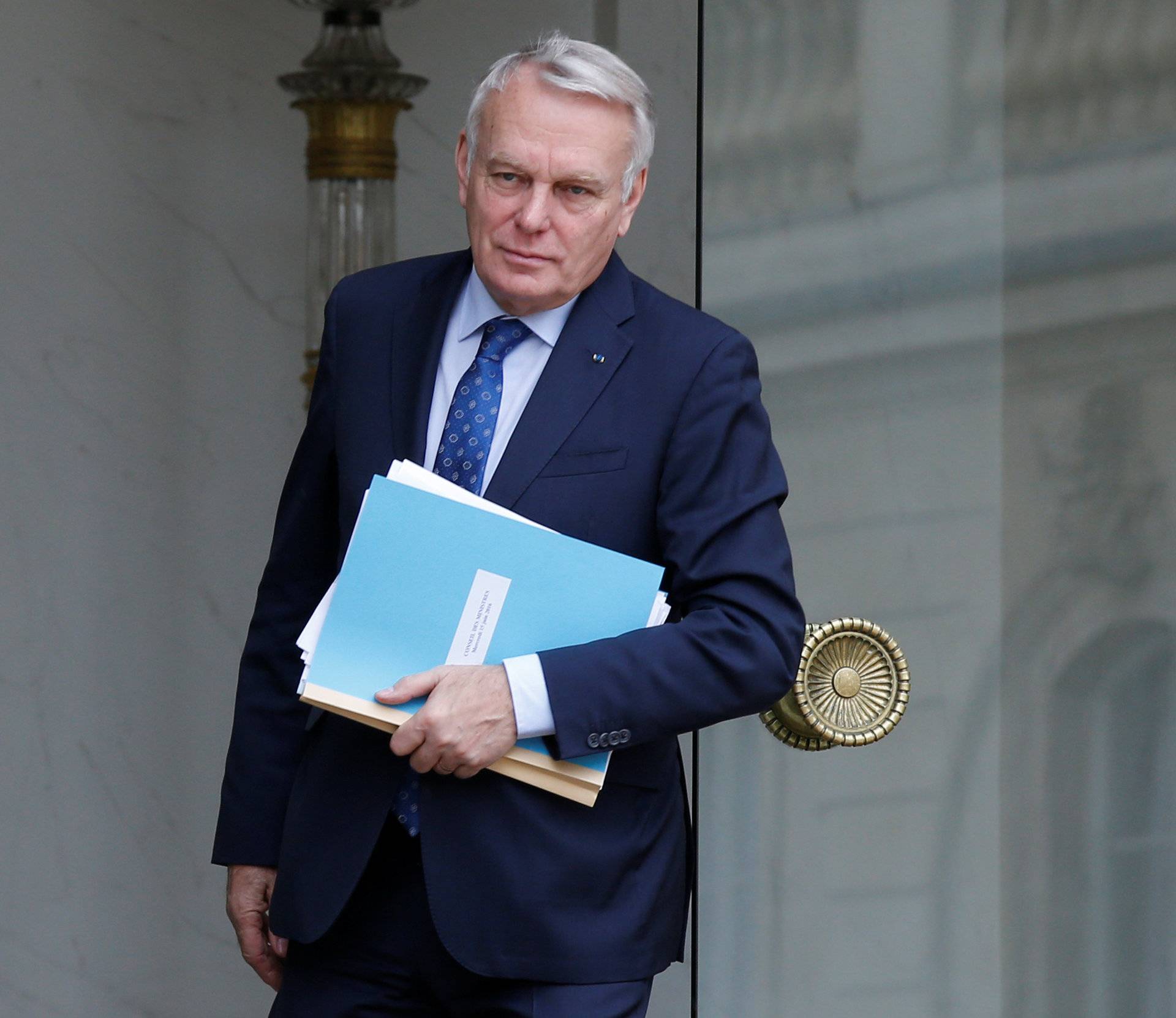 French Foreign Minister Jean-Marc Ayrault leaves the weekly cabinet meeting at the Elysee Palace in Paris