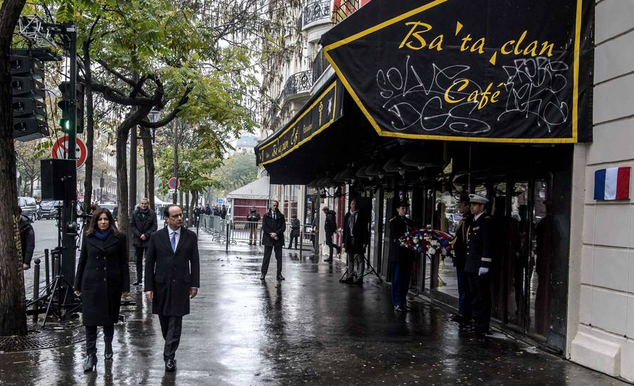 French President Francois Hollande and Paris Mayor Anne Hidalgo unveil a commemorative plaque in front of the Bataclan concert hall