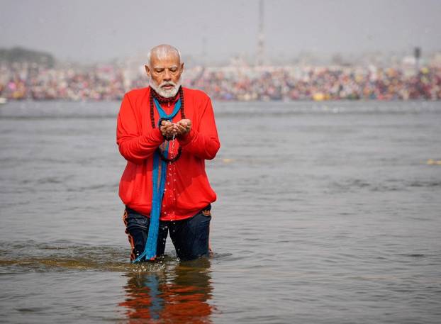 India's Prime Minister Narendra Modi prays as he takes a holy dip during the ongoing "Maha Kumbh Mela", or the Great Pitcher Festival, in Prayagraj