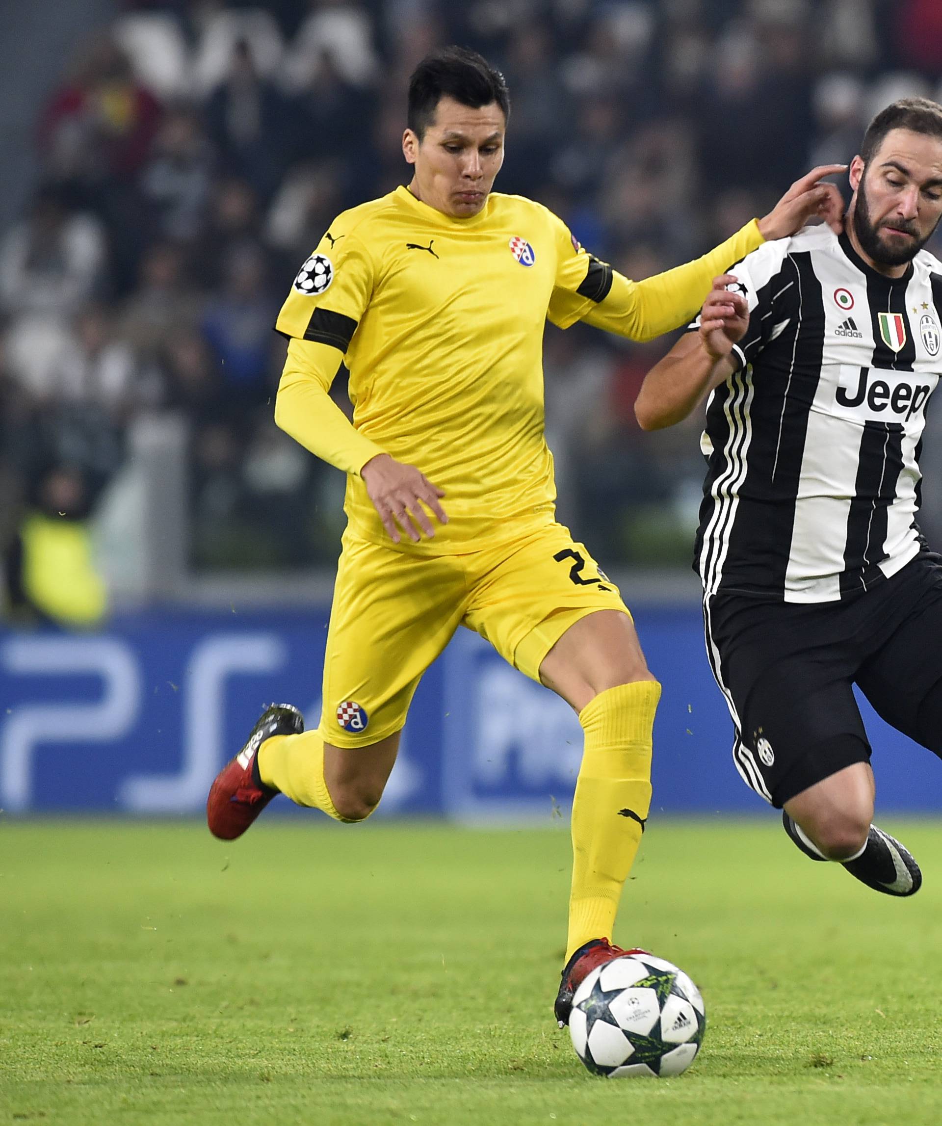 Dinamo Zagreb's Leonardo Sigali in action with Juventus' Gonzalo Higuain