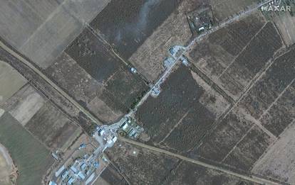 A satellite image shows refugees and cars waiting to cross into Hungary from Ukraine, at the Luzhanka Border crossing