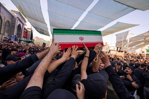 Mourners carry the coffins of family members of Iran’s late Supreme Leader Ayatollah Ali Khamenei, inside the shrine of Imam Abbas during funeral ceremonies in Karbala