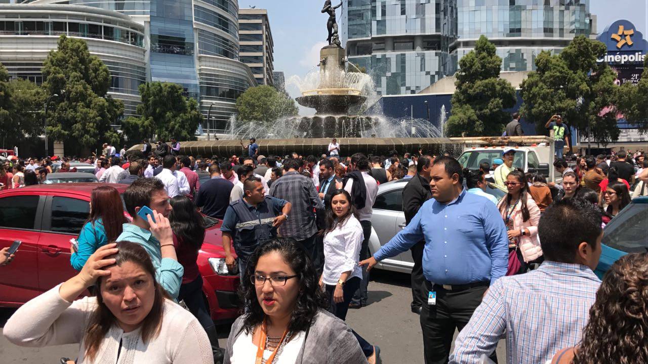 People react after an earthquake hit in Mexico City