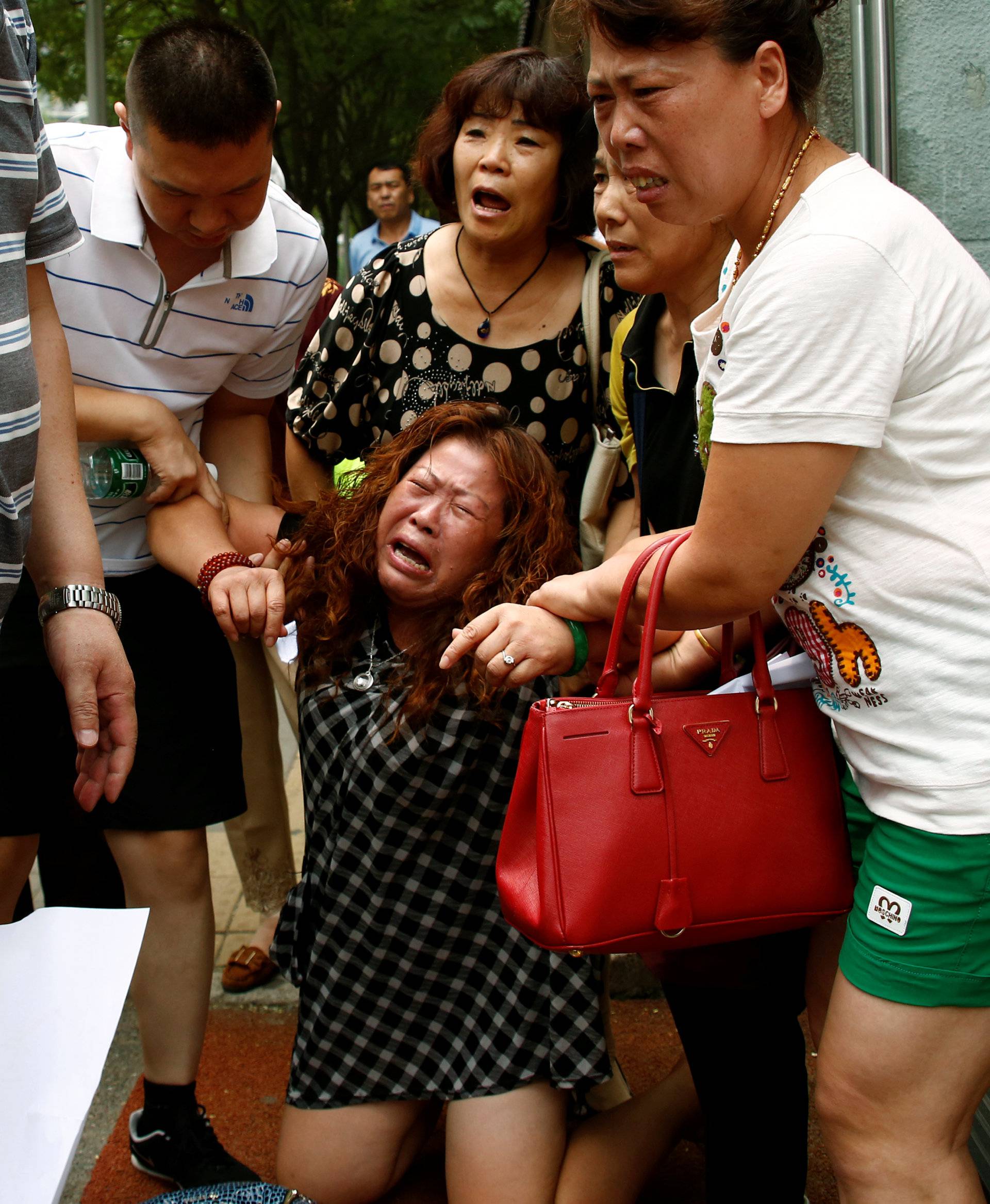 A family member of a passenger aboard Malaysia Airlines flight MH370 which went missing in 2014 reacts during a protest outside the Chinese foreign ministry in Beijing