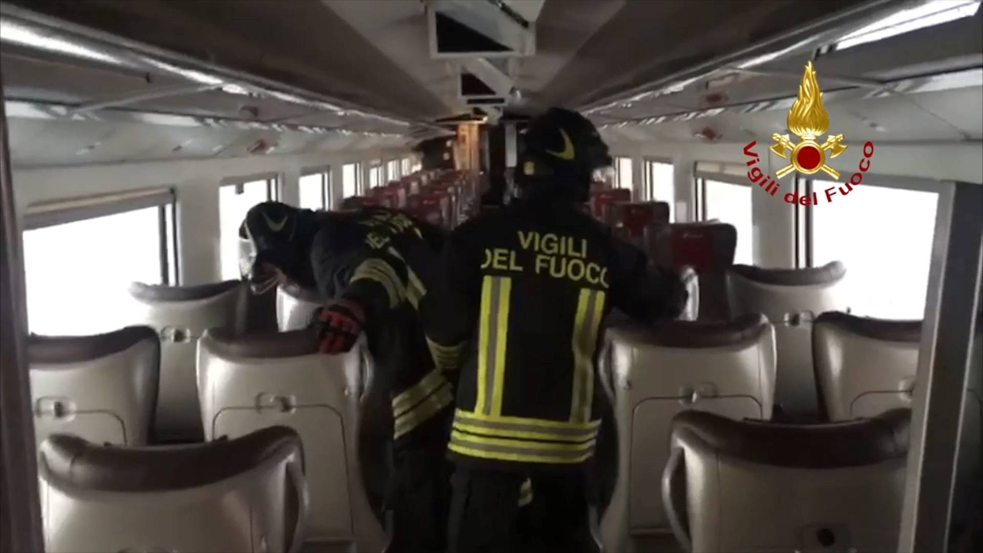 Firefighters inspect a carriage inside a high-speed train after which derailed travelling between Milan and Bologna