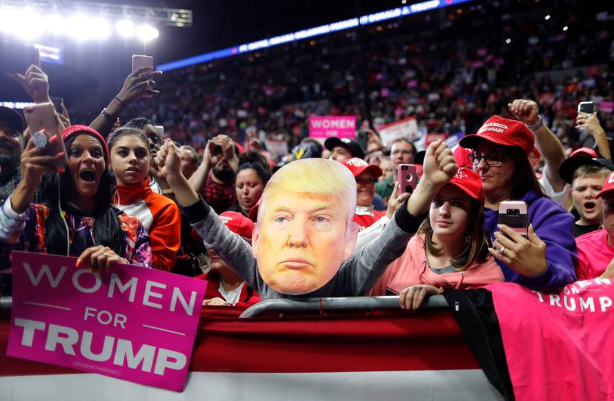 Supporters participate behind an image of U.S. President Donald Trump at a campaign rally at the Allen County War Memorial Coliseum in Fort Wayne