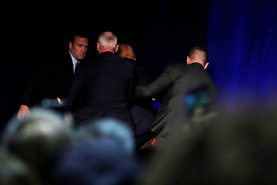 Republican presidential nominee Donald Trump is hustled off the stage by security agents following a perceived threat in the crowd at a campaign rally in Reno, Nevada