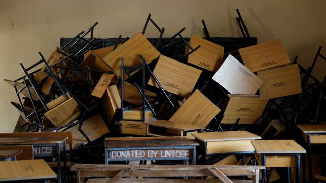 Broken chairs are piled up in a classroom at Yaskule girls secondary school in Michika village