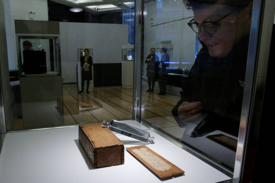 A man looks at a prism belonging to Benjamin Franklin which is displayed at Bonhams auction house in New York