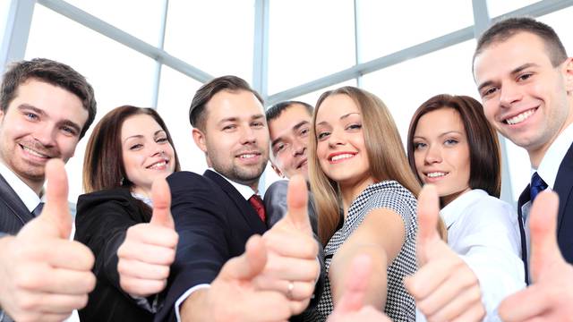 Successful,Young,Business,People,Showing,Thumbs,Up,Sign