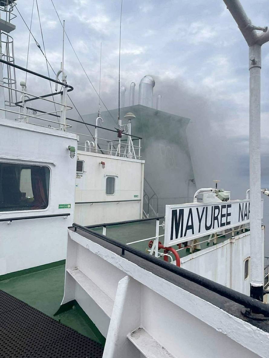 The Thailand-flagged cargo ship Mayuree Naree engulfed in black smoke in the Strait of Hormuz