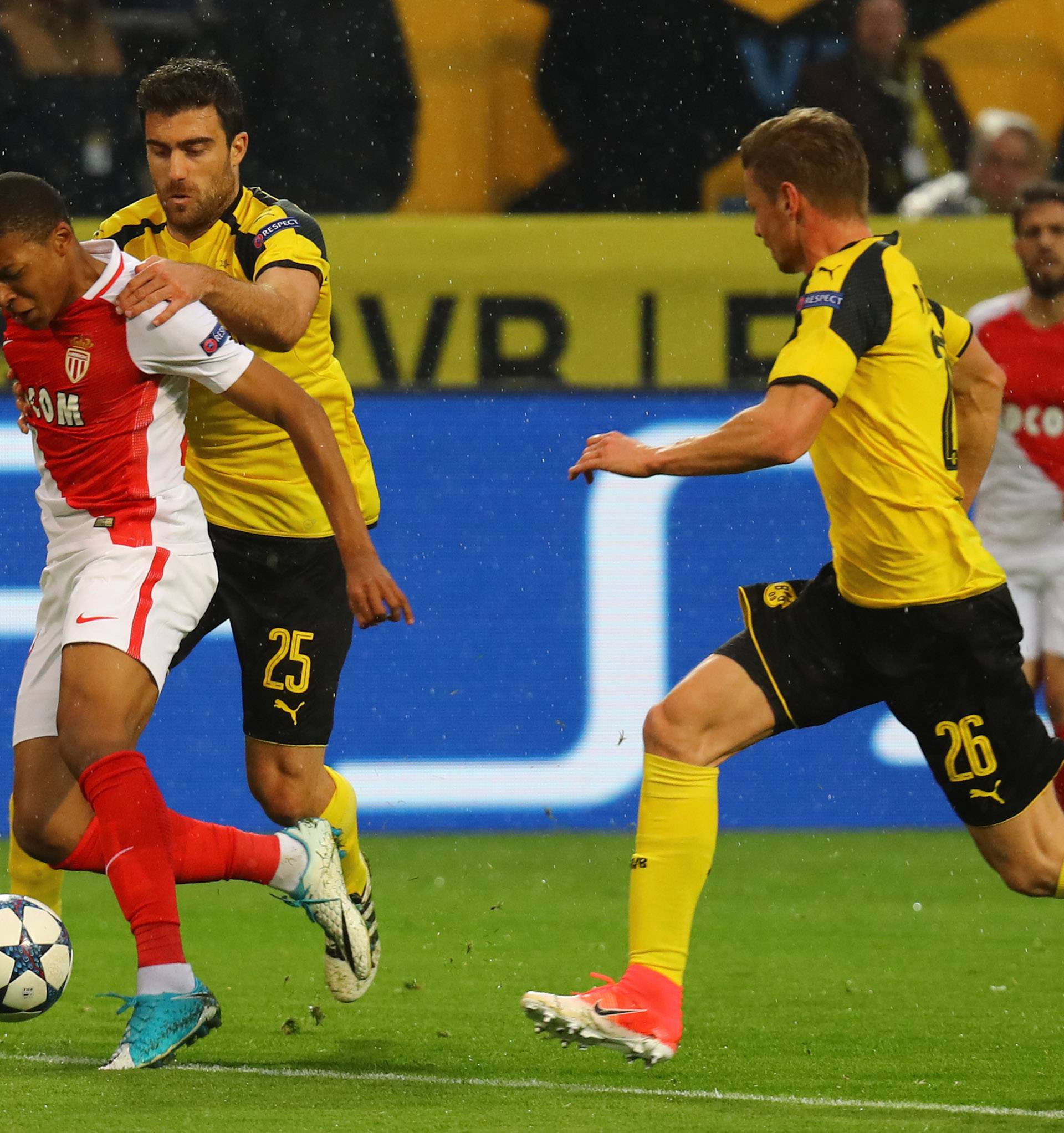 Borussia Dortmund's Sokratis Papastathopoulos fouls Monaco's Kylian Mbappe-Lottin for a penalty