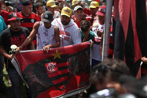 Fans of Brazilian football club Flamengo gather to lay flowers at the club