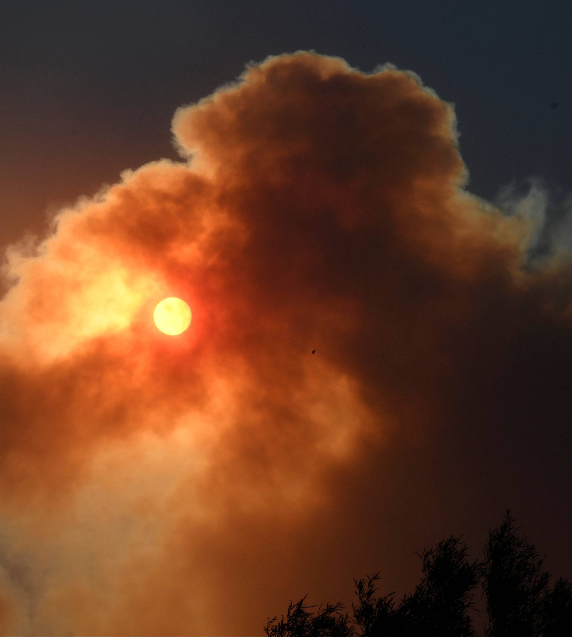 The morning sun is block by the thick smoke from an early-morning Creek Fire that broke out in the Kagel Canyon area in the San Fernando Valley north of Los Angeles in Sylmar