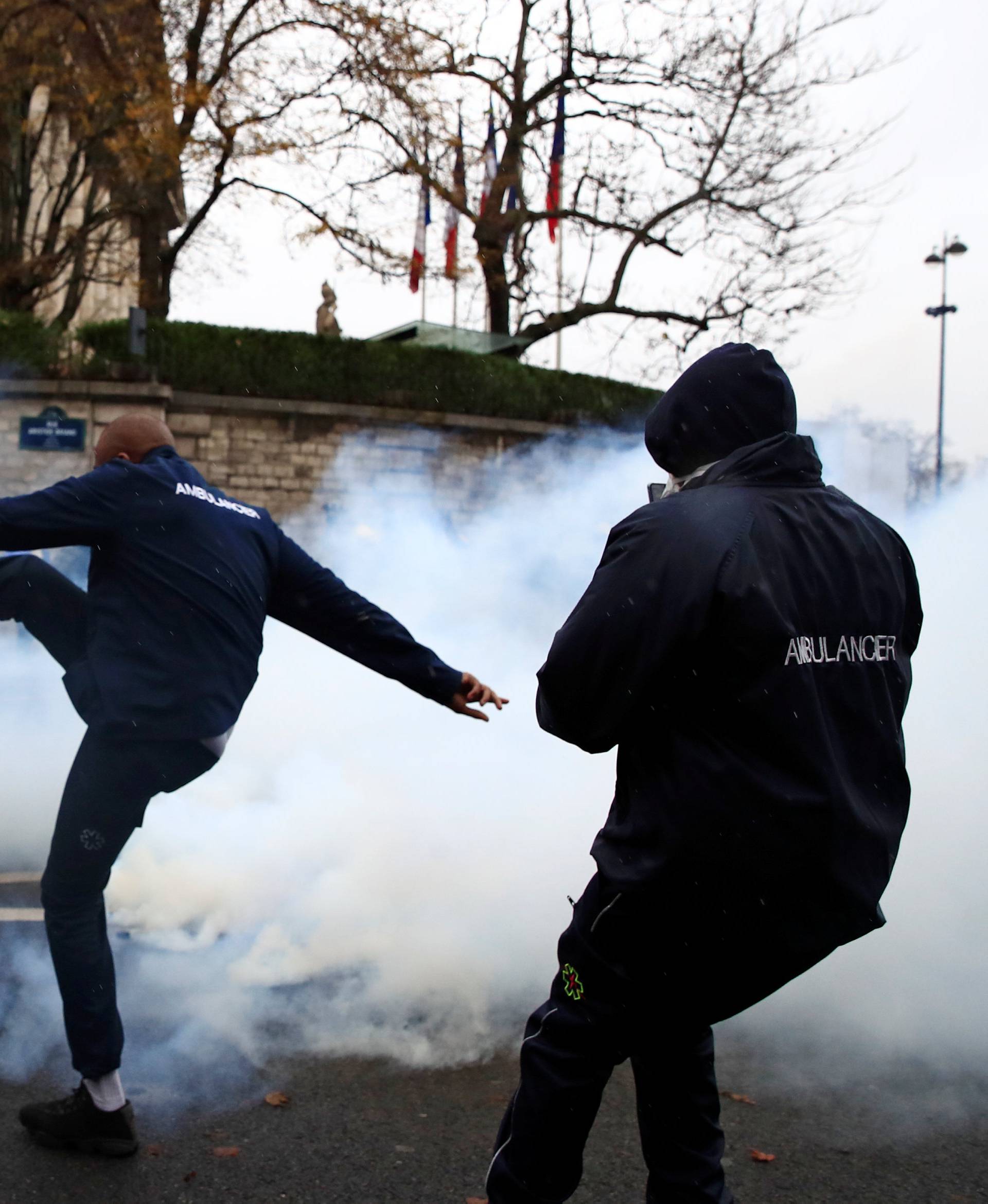 French ambulance drivers face off with French riot police during a demonstration at the Place de la Concorde in Paris