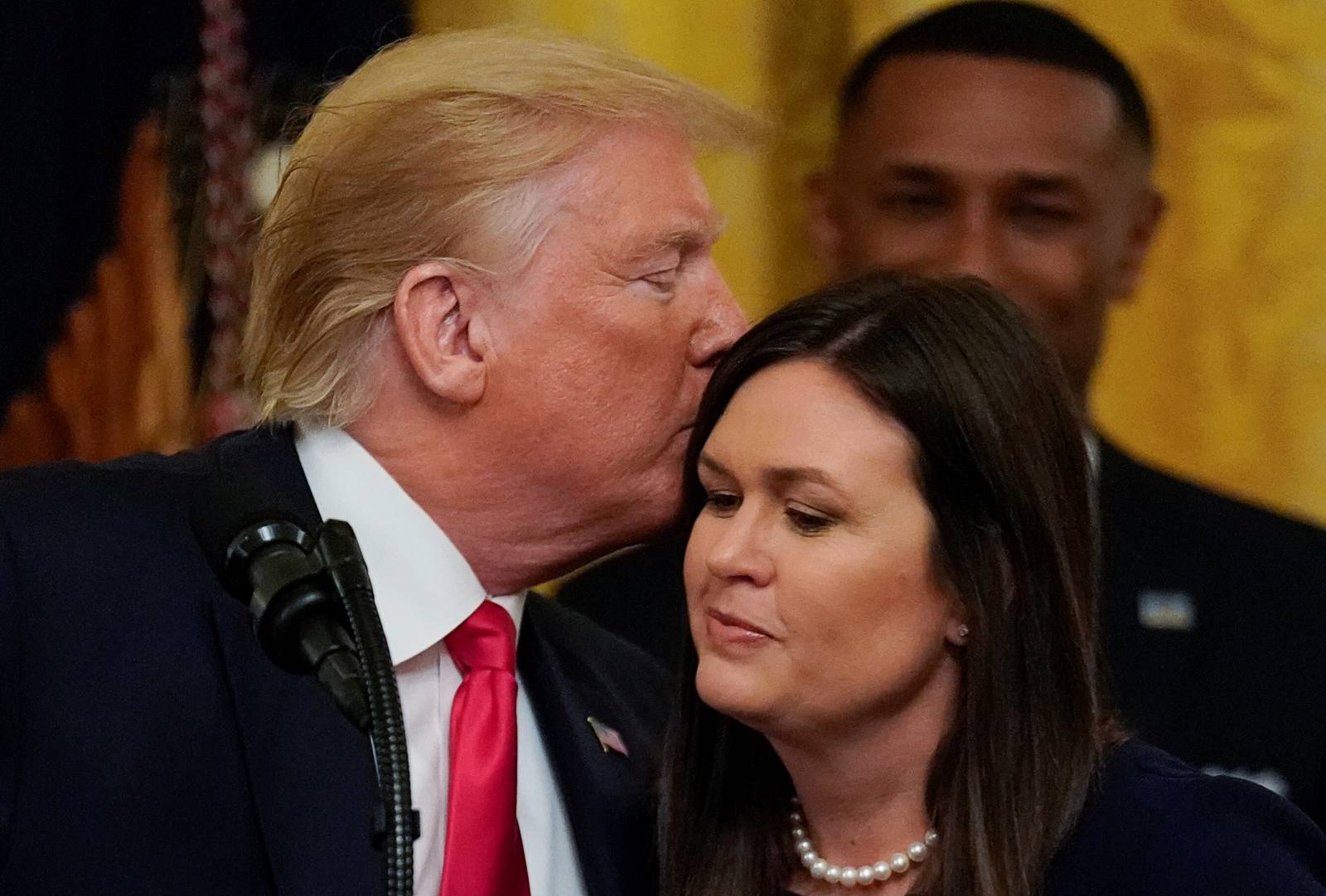 U.S. President Trump kisses press secretary Sanders during "second chance hiring" prisoner reentry event at the White House in Washington