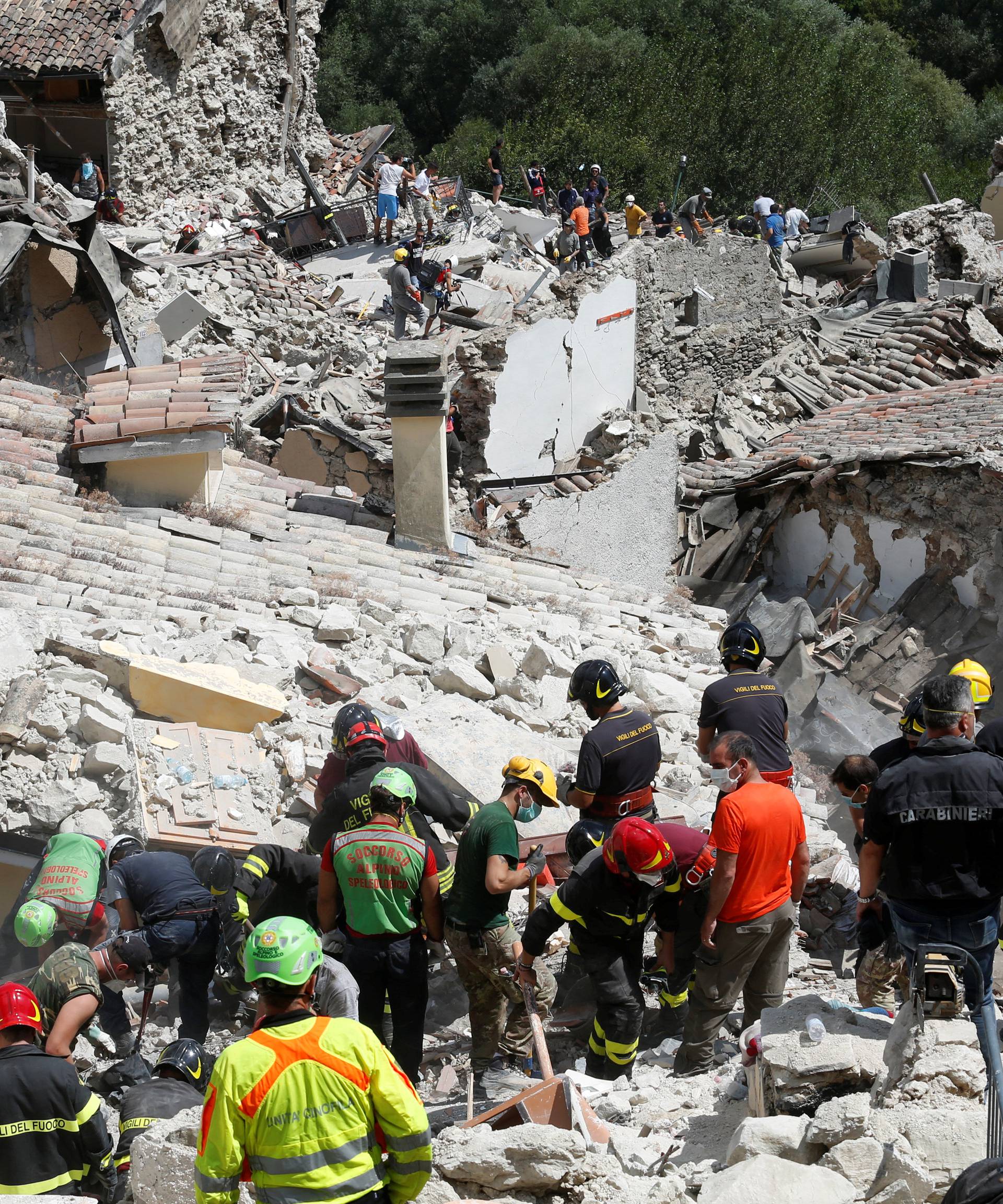 Rescuers work following an earthquake at Pescara del Tronto