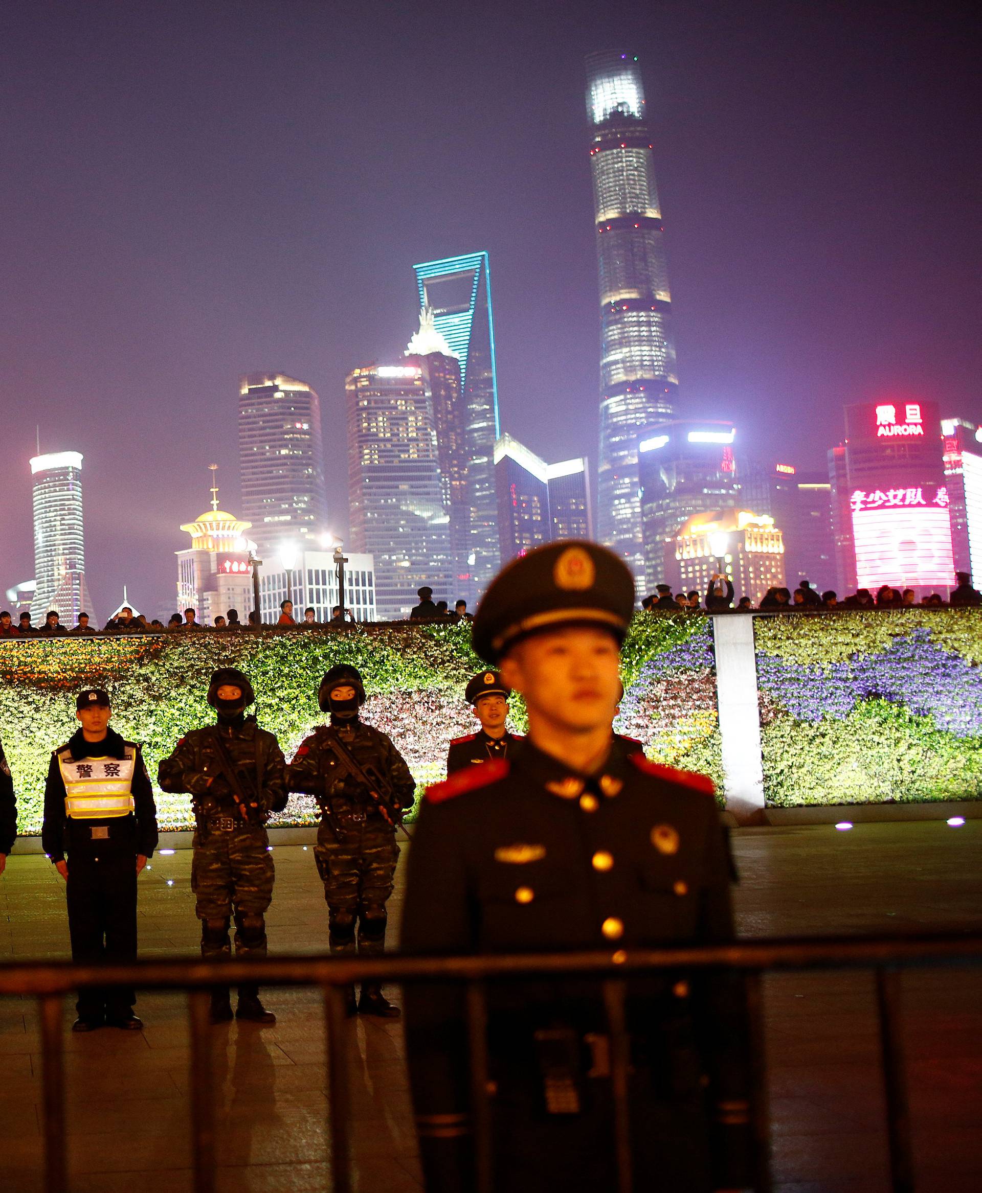 Police officers stand guard at the location where a stampede incident occurred during New Year celebrations two years ago, on the Bund in Shanghai,