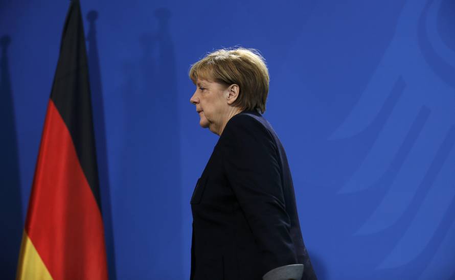 German Chancellor Angela Merkel leaves a news conference in Berlin