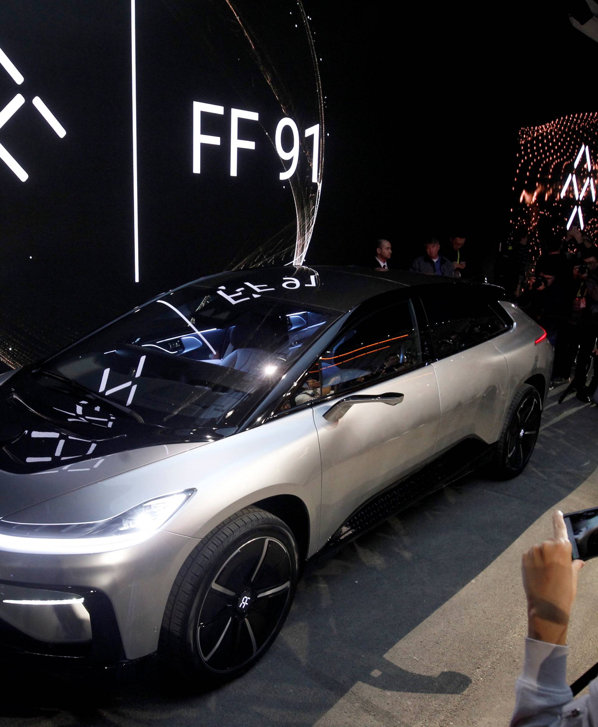 A Faraday Future FF 91 electric car is displayed on stage during an unveiling event at CES in Las Vegas