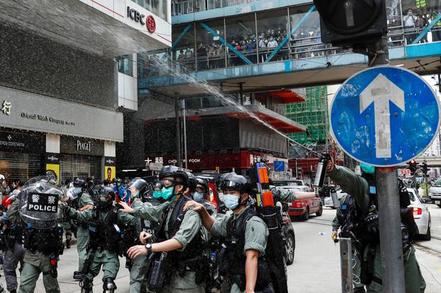Riot police use pepper spray to disperse anti-government protesters in Hong Kong